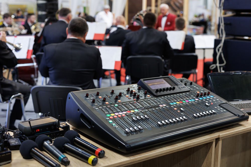 Large LED wall and sound console setup at a live event